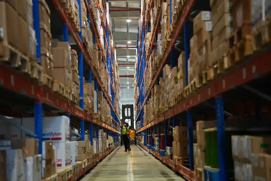 Agent de sécurité marchant dans un entrepôt vide, surveillance et gardiennage de site logistique à Paris